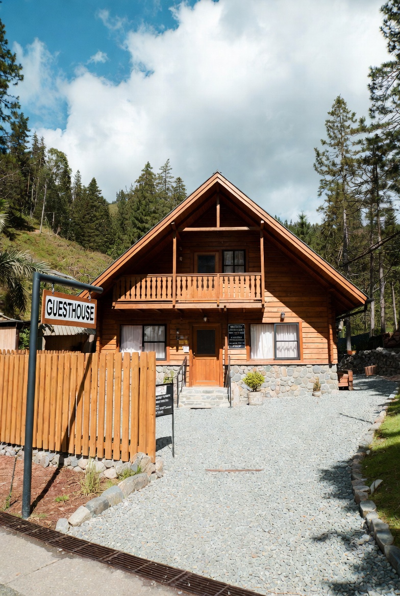 A clean, well-styled guesthouse room with fresh linens, natural light, and simple local touches prepared for a new arrival